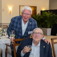 Don Lubbers sitting and Don Paton standing behind him, both smiling for camera